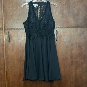 Anna black halter cocktail dress featuring a sheer floral lace back fully lined